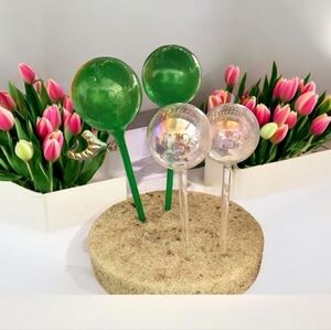 Green and Clear Watering spikes, four piece set green, plastic glass clear.